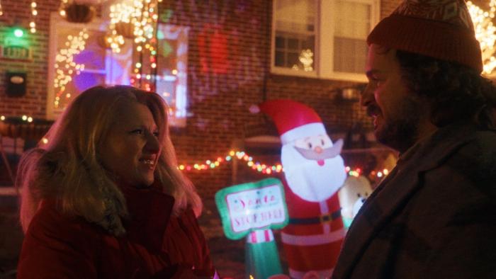 The Baltimorons Movie: Didi and Cliff smile at one another while talking in front of a house that's decorated for Christmas