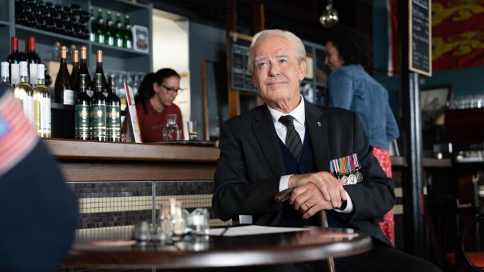 The Last Rifleman Movie: Pierce Brosnan as a World War II veteran sits in a pub.