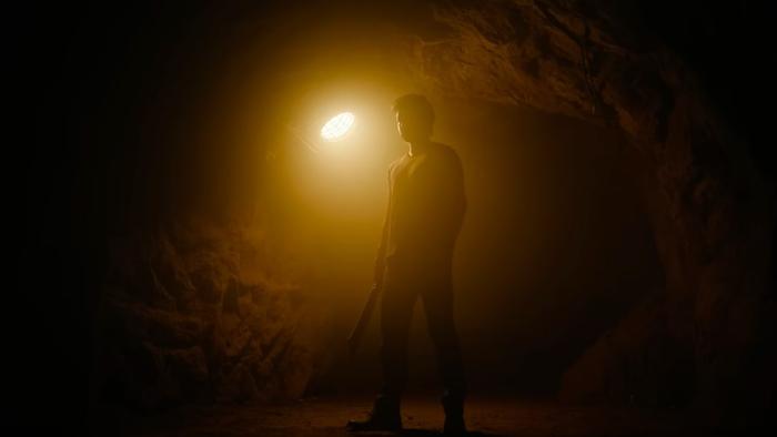 Beast: A silhouette of a character holding a machete with a yellow spotlight in the background