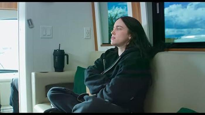 Billie Eilish Hit Me Hard and Soft movie: Eilish sits on a couch, eyes closed, in a hotel room during her concert tour