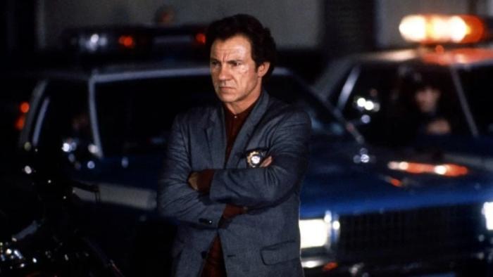 Bad Lieutenant: Harvey Keitel leans against a police car with his arms crossed