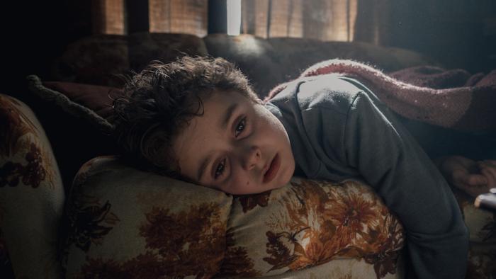Blood Movie: Owen lies on a couch, looking ill (or hungry)