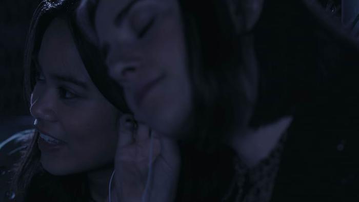 Bloody Axe Wound Movie: Abbie and Sam lean their heads together to share headphones and listen to a song