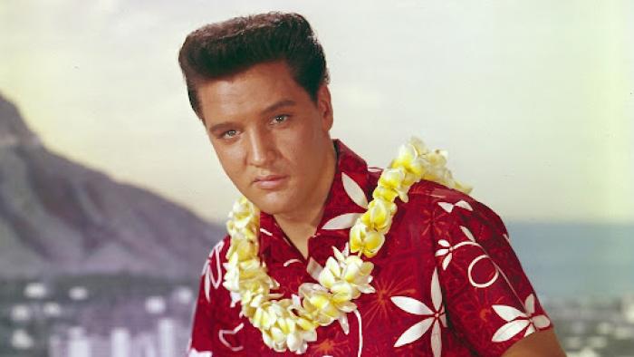 Blue Hawaii: Elvis Presley wears a Hawaiian shirt and a lei against an ocean backdrop