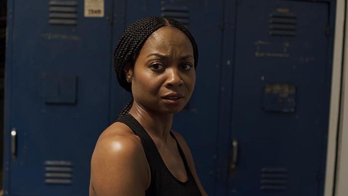 Bobcat Moretti Movie: Sheria Irving looks concerned as she stands in front of changing room lockers