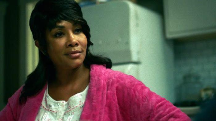 Bosco movie: Vivica A. Fox in pink robe and white shirt left stands in kitchen with refridgerator behind her