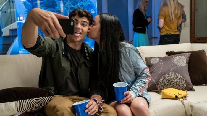 To All the Boys I've Loved Before movie: Lara Jean kisses Peter on the cheek while he takes a selfie