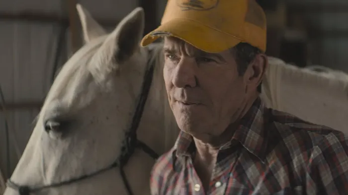 Broke movie: Dennis Quaid in yellow baseball cap center stands next to white horse