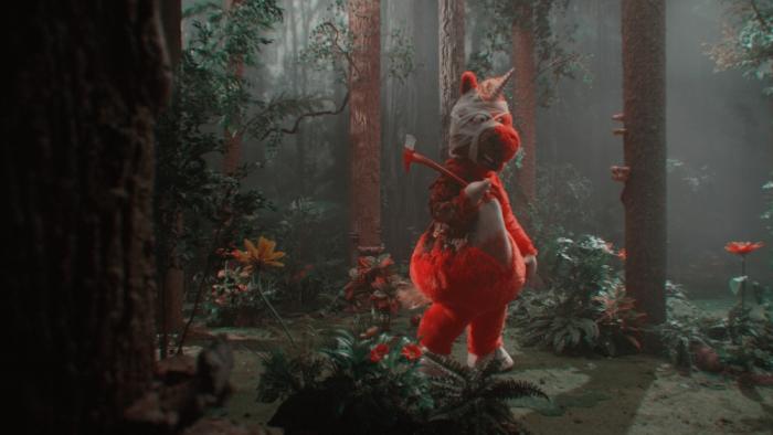 Buddy Movie: Buddy, covered in scars and bandages, walks through the woods with an axe slung over his shoulder