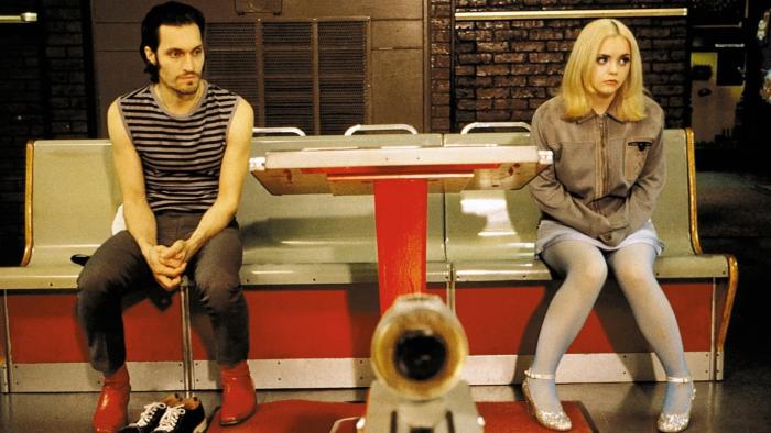 Buffalo '66: A man and woman sit on a diner bench, looking in opposite directions