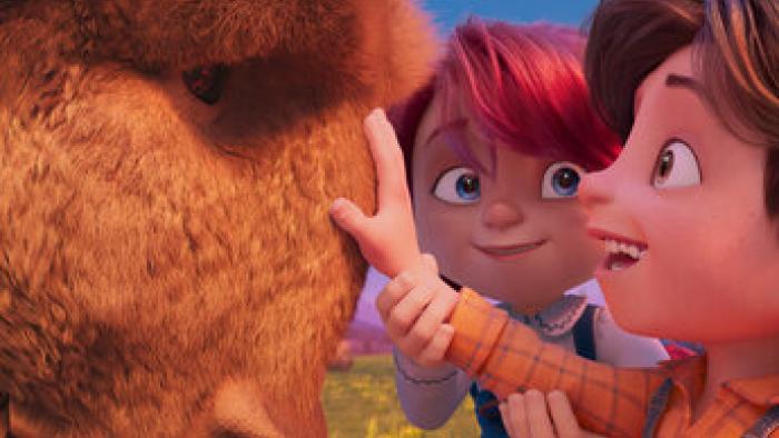 Buffalo Kids: A boy smiles as he touches a buffalo's face as a girl looks at him
