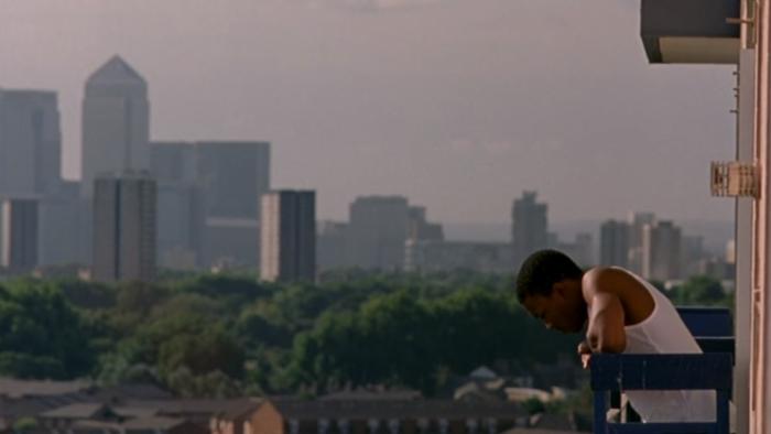 Bullet Boy: Ashley Walters stands on a balcony in a white vest with London high-rise buildings in the background