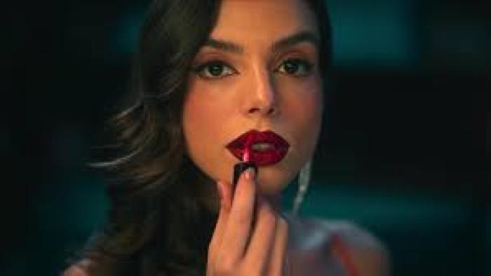 Burning Betrayal scene 3: Woman applies bright lipstick