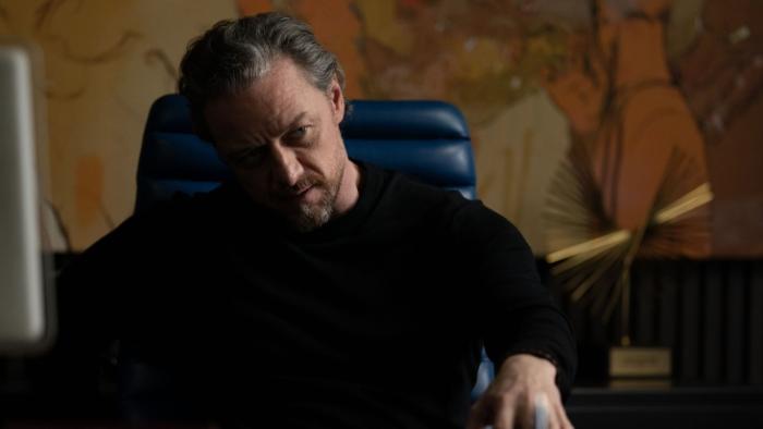 California Schemin': Man sitting in a chair, deep in thought, in a dimly lit room