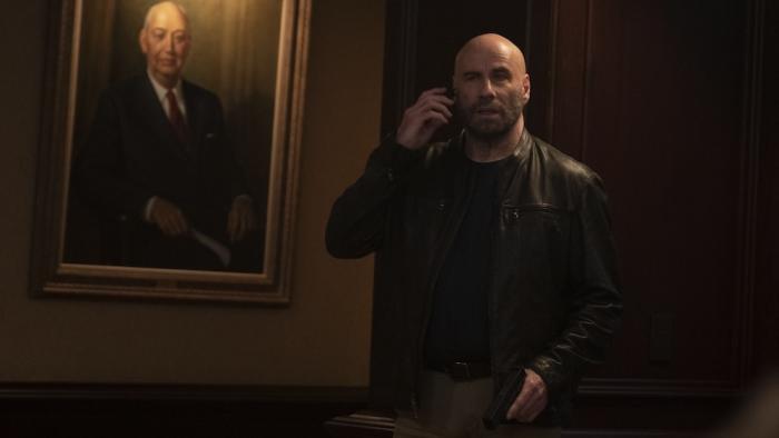 Cash Out Movie: In the bank, next to a portrait of a banker, Mason speaks on a cell phone, looking concerned