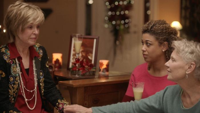 Chantilly Bridge Movie: Inside a home, an older White woman comforts another by holding her hand, while a young Black woman looks on with concern