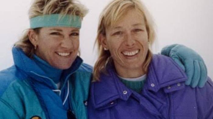 Chris & Martina: The Final Set: Chris and Martina smiling, wearing blue and purple winter jackets, in a snowy setting.