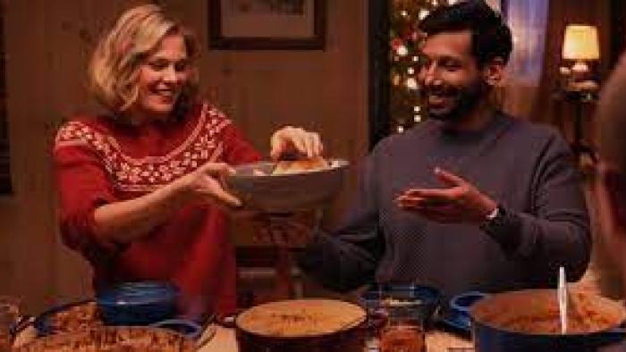 Christmas as Usual scene 3: White woman and Indian man share a meal