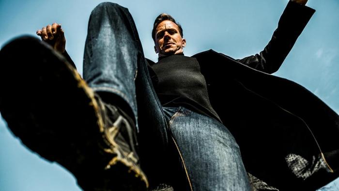 Citizen Vigilante: A White man stamps on a person, the camera looking up from the victim's point of view