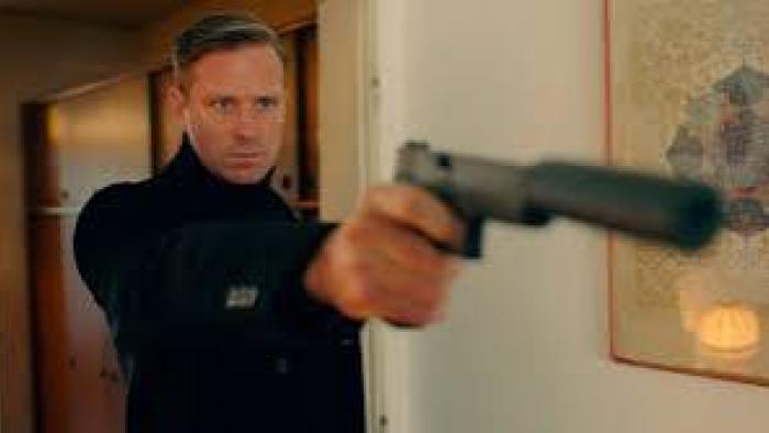 Citizen Vigilante: A White man points a pistol at someone out of shot