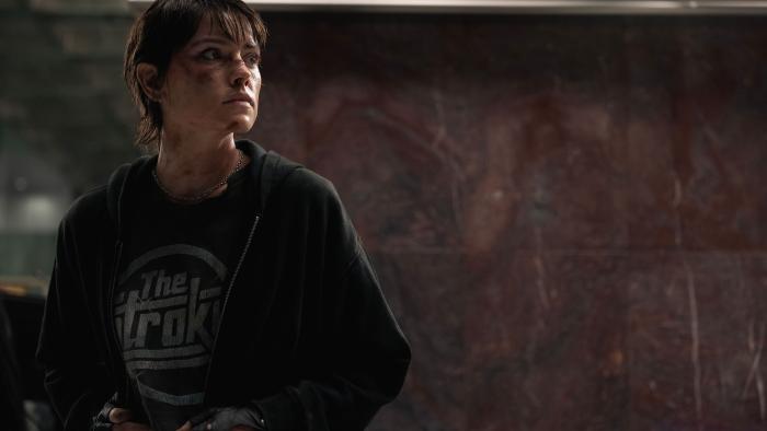 Cleaner: A bruised woman in a hoodie and gloves looks warily into the distance