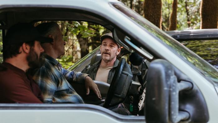 Clear Cut Movie: Jack (Clive Standen) and Sam (Alec Baldwin) stop their pickup truck to speak with ranger Ike (Stephen Dorff)