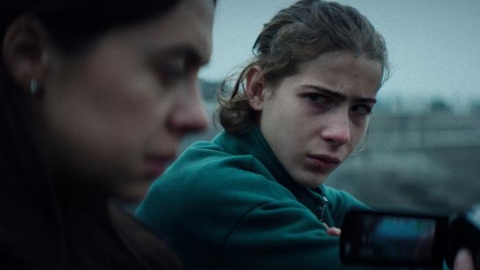 Cold Copy Movie: Jacob Tremblay looks in a concerned way at Bel Powley