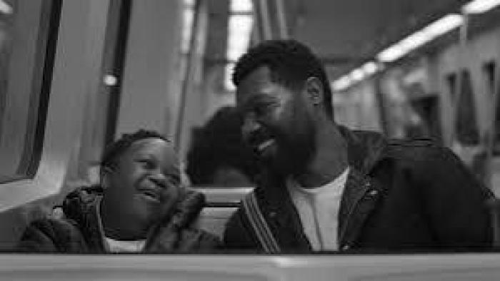 Color Book: Black father and child smiling on a train.