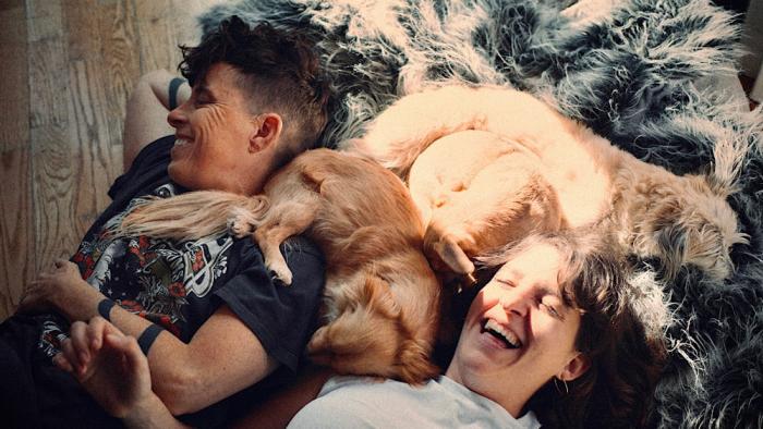 Come See Me in the Good Light movie: Andrea Gibson and Megan Falley lie on the floor with their three dogs
