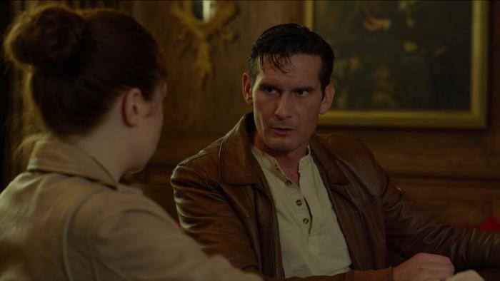 Condor's Nest Movie: Will Spalding in deep discussion with Leyna Rahn, whose back is to viewers