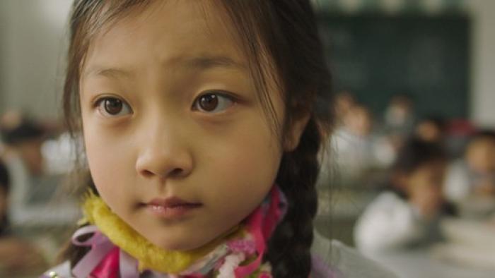 Confetti Movie: Wearing her colorful homemade scarf, Meimei is in class, looking slightly uneasy