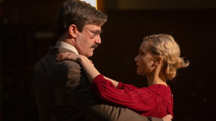 Corner Office Movie: Jon Hamm dances with a blonde woman in a red dress (Sarah Gadon)