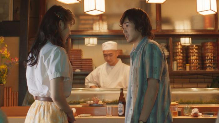 Cottontail: Yuri Tsunematsu and Kosei Kudo stand looking at each other in front of a restaurant bar