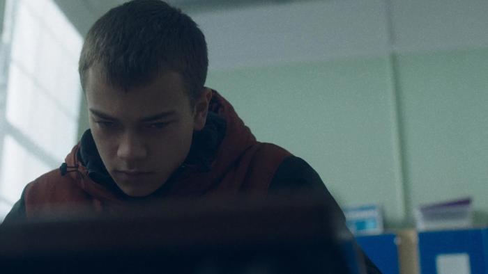 County Lines: A young teenage boy looks down at his desk as he sits in a classroom