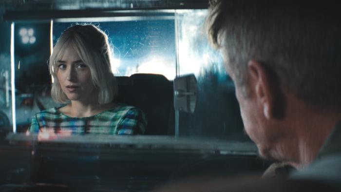 Daddio Movie: Cab driver Clark (Sean Penn) turns around to speak to his passenger (Dakota Johnson) in the back seat
