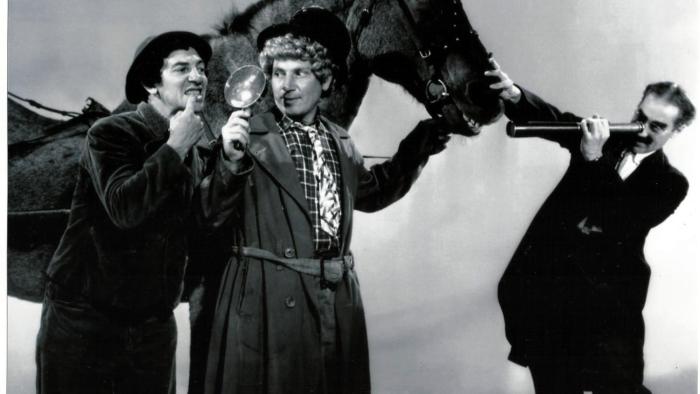 A Day at the Races Movie: Black and white scene of three men examining a horse and its teeth