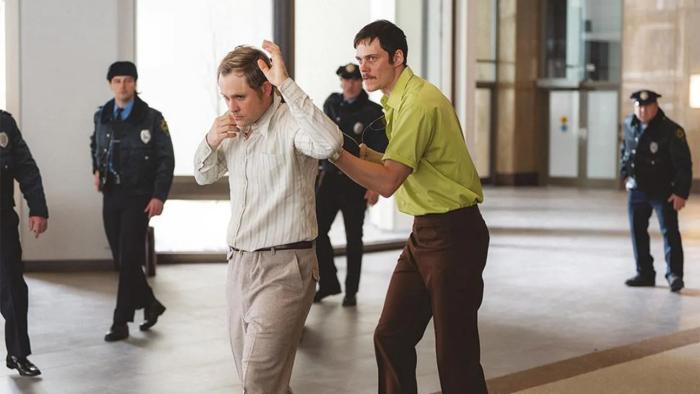 Dead Man's Wire movie: Tony Kiritsis (Bill Skargard) holds a shotgun to the head of the head of a mortgage lender (Dacre Montgomery)