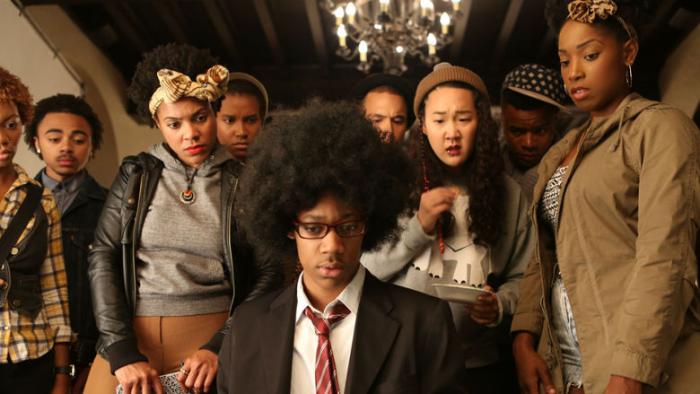 Dear White People movie: A crowd of students gather around Lionel, all appearing to look down at a laptop (off-screen)