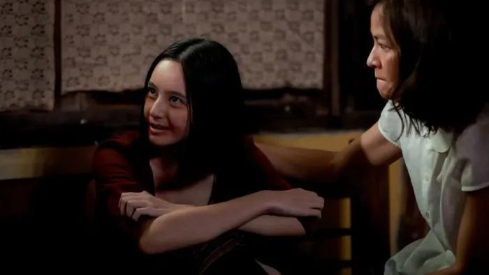 Death Whisperer movie: Thai girl with blood around mouth center left smiles with Thai woman in white to her right