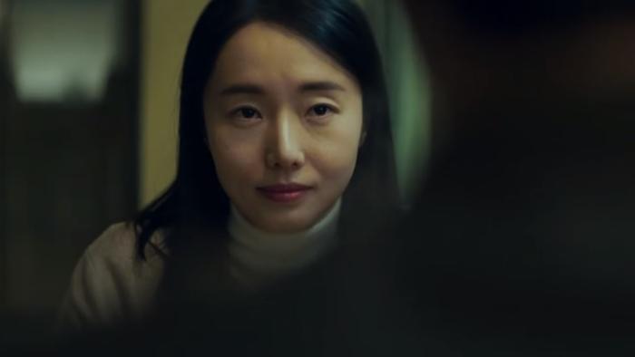 Decision to Leave: A Chinese woman looks at person opposite who is in silhouette