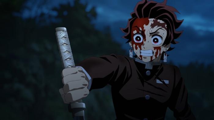 Tanjiro has determined eyes while gripping his sword tightly, his face covered with blood as he stands in a dark forest.