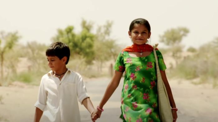 Rainbow: A young Indian brother and sister walk together