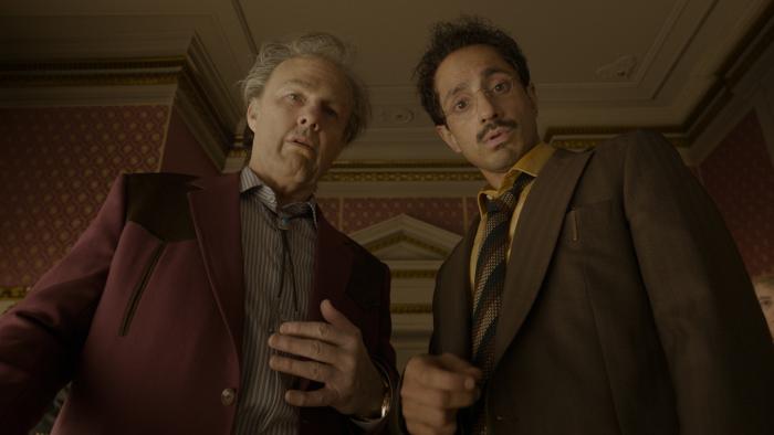 Digger movie: Rockwell (Tom Cruise) and Dr. Ganesh (Riz Ahmed) look startled at something beneath them