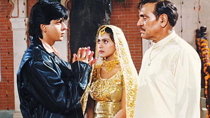 Dilwale Dulhania Le Jayenge: Kajol and Shah Rukh Khan as a young couple, with Amrish Puri as a stern father 