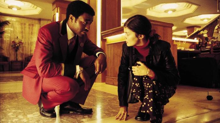 Dirty Pretty Things: Chiwetel Ejiofor bends down next Audrey Tautou in a hotel lobby
