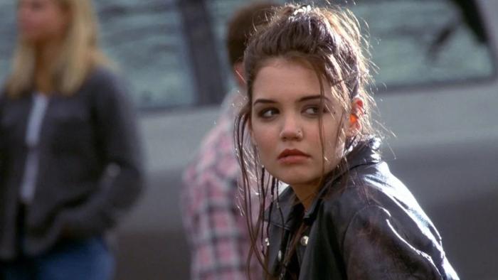 Disturbing Behavior: Young woman with dark hair looks concerned, wearing a leather jacket in an outdoor setting