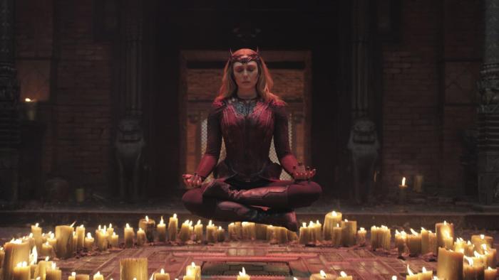 Doctor Strange in the Multiverse of Madness Movie: A woman floats cross-legged above a circle of candles