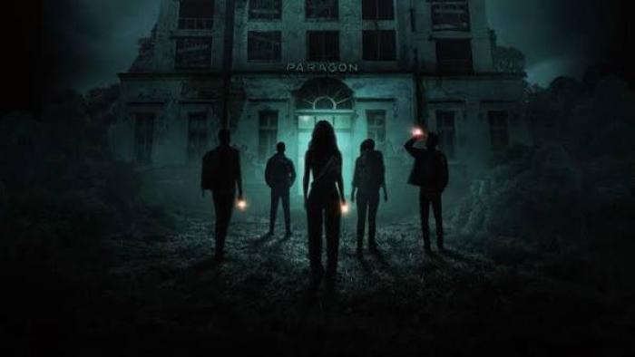 Do Not Enter Movie: Silhouetted figures with flashlights near a haunted house at night.