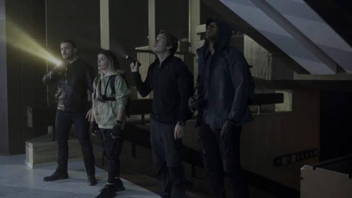 Do Not Enter Movie: Four people exploring a dark building with flashlights.