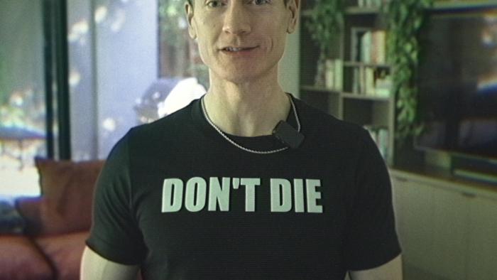 Don't Die: The Man Who Wants to Live Forever movie: White middle-aged man in black t-shirt with text that says, "DON'T DIE" in white letters